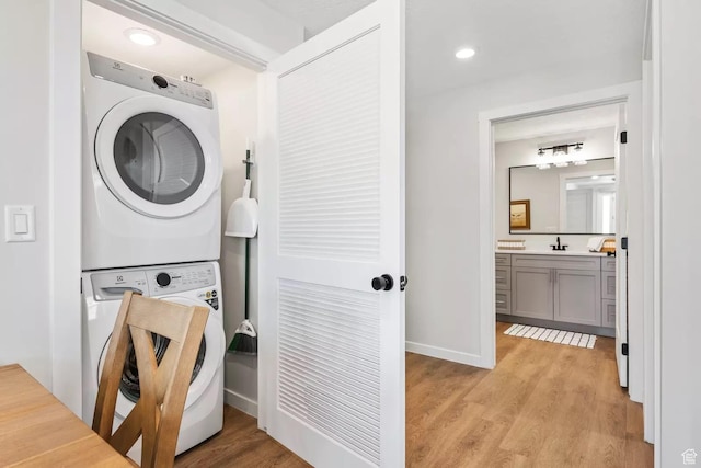 875 W Akoya Pearl St S Unit 101-B, St George, UT 84790 - laundry area featuring stacked washing machine and dryer, light wood-style floors, and baseboards