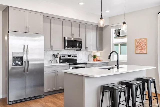 875 W Akoya Pearl St S Unit 101-B, St George, UT 84790 - kitchen featuring stainless steel appliances, gray cabinets, a sink, backsplash, and light countertops