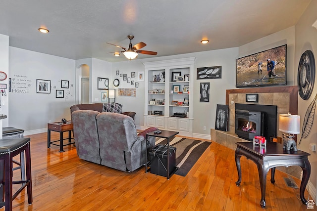 3173 N 1050 W, Pleasant View, UT 84414 - living area featuring a ceiling fan, arched walkways, baseboards, and light wood-style floors
