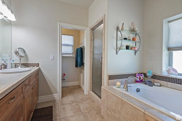 3173 N 1050 W, Pleasant View, UT 84414 - full bath featuring a shower stall, baseboards, vanity, a garden tub, and tile patterned flooring
