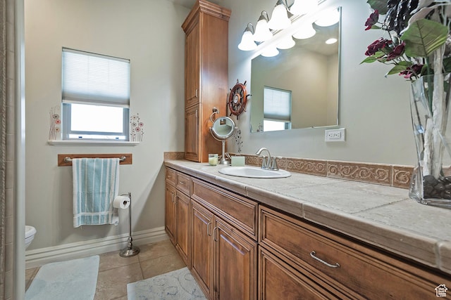 3173 N 1050 W, Pleasant View, UT 84414 - bathroom with baseboards, toilet, tile patterned flooring, and vanity