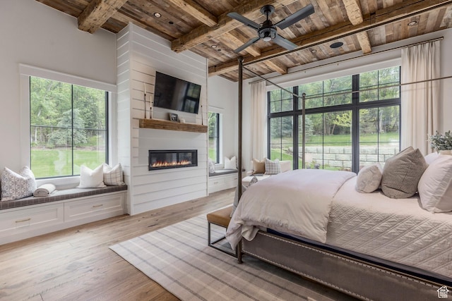 1230 S Eaglenest Dr, Woodland Hills, UT 84653 - bedroom with wooden ceiling with exposed beams, light wood-style floors, and a large fireplace