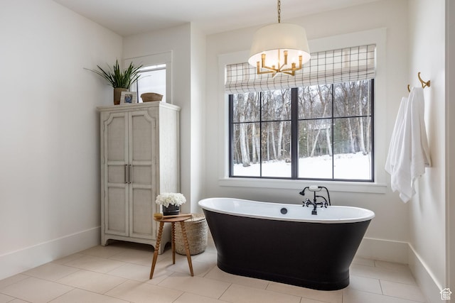 1230 S Eaglenest Dr, Woodland Hills, UT 84653 - bathroom featuring a freestanding tub, a chandelier, baseboards, and tile patterned flooring