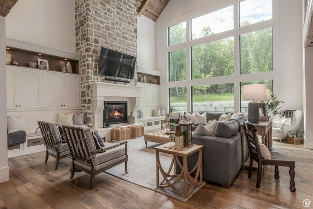1230 S Eaglenest Dr, Woodland Hills, UT 84653 - living room with high vaulted ceiling, wood-type flooring, a fireplace, and beamed ceiling