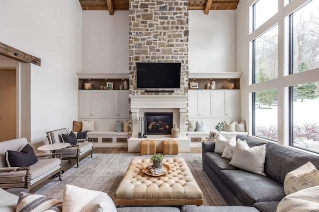 1230 S Eaglenest Dr, Woodland Hills, UT 84653 - living area featuring a high ceiling, healthy amount of natural light, a large fireplace, wooden ceiling with exposed beams, and light wood-type flooring