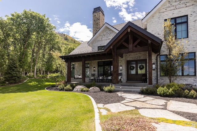 1230 S Eaglenest Dr, Woodland Hills, UT 84653 - entrance to property with a yard, a chimney, brick siding, french doors, and a porch