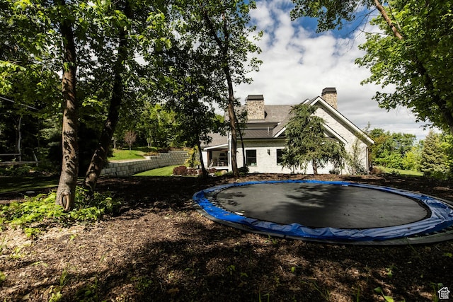 1230 S Eaglenest Dr, Woodland Hills, UT 84653 - rear view of property with a trampoline and a chimney