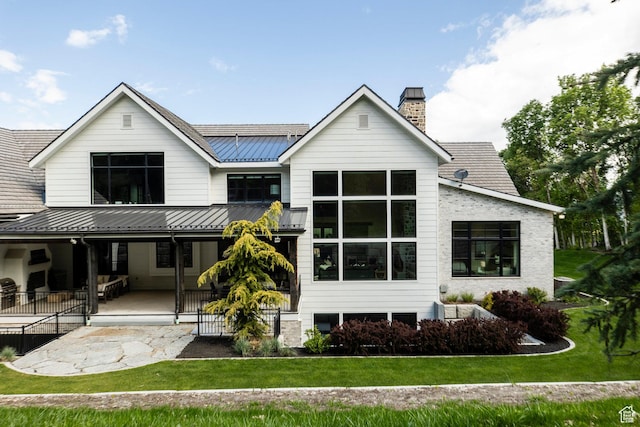 1230 S Eaglenest Dr, Woodland Hills, UT 84653 - back of house featuring metal roof, a lawn, a standing seam roof, and a chimney
