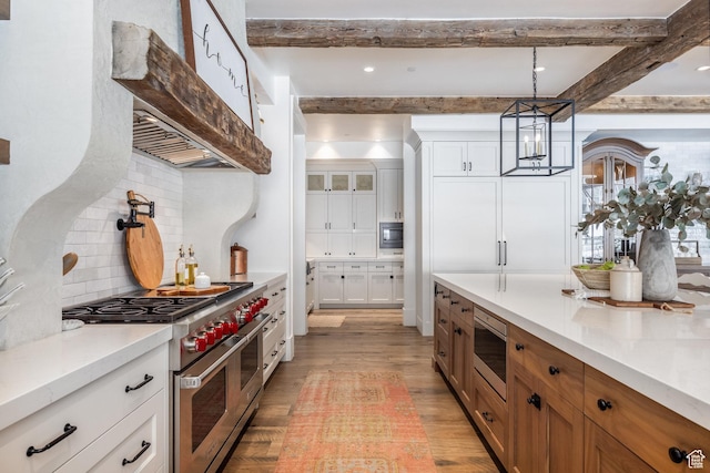 1230 S Eaglenest Dr, Woodland Hills, UT 84653 - kitchen featuring stainless steel appliances, light wood-type flooring, beam ceiling, decorative backsplash, and light countertops