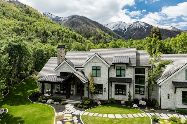 1230 S Eaglenest Dr, Woodland Hills, UT 84653 - view of front of property featuring covered porch, a mountain view, a standing seam roof, and a chimney