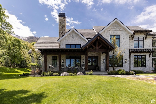 1230 S Eaglenest Dr, Woodland Hills, UT 84653 - view of front of home featuring brick siding, a front lawn, a chimney, and a porch