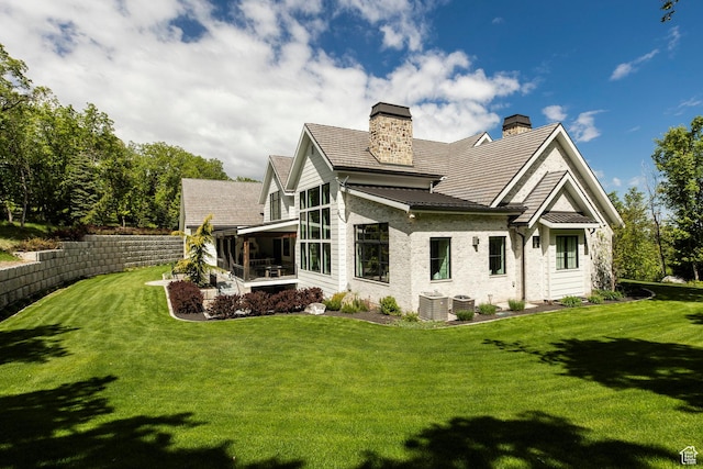 1230 S Eaglenest Dr, Woodland Hills, UT 84653 - rear view of property with a sunroom, a chimney, a yard, and central AC unit