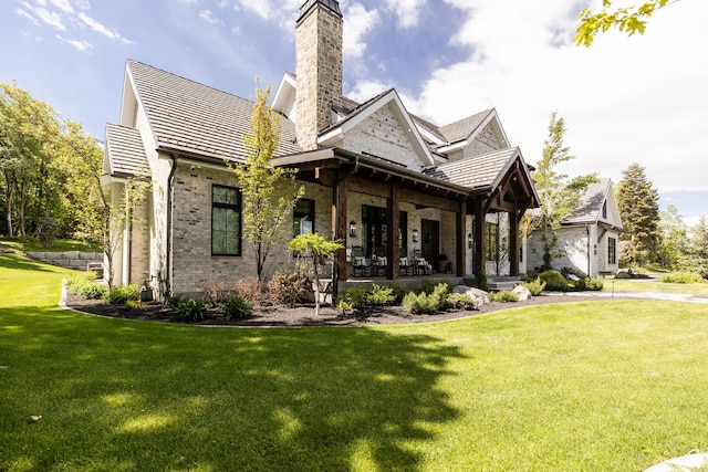 1230 S Eaglenest Dr, Woodland Hills, UT 84653 - back of property with a yard, brick siding, a chimney, and covered porch