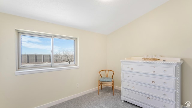 bedroom featuring light carpet and baseboards