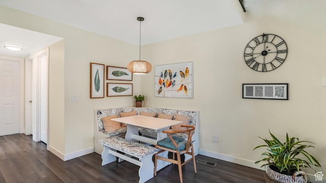 dining area with baseboards, visible vents, dark wood-type flooring, and breakfast area