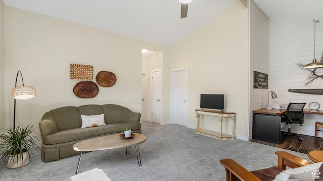 living area with carpet flooring, high vaulted ceiling, baseboards, and ceiling fan