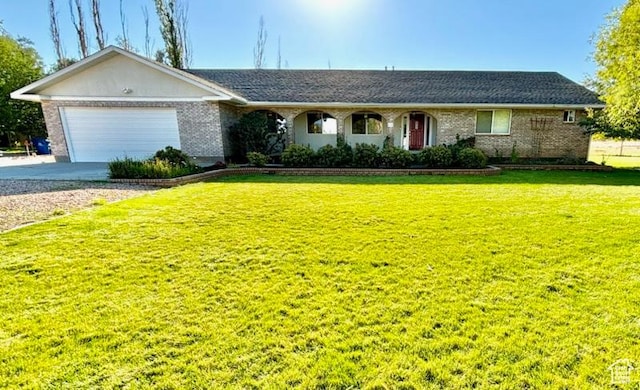 430 E Canyon Rd, Fillmore, UT 84631 - ranch-style home featuring driveway, a front yard, an attached garage, and brick siding