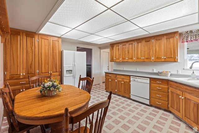 430 E Canyon Rd, Fillmore, UT 84631 - kitchen with light countertops, a sink, light floors, brown cabinetry, and white appliances