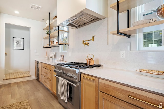 kitchen featuring premium range hood, visible vents, high end stove, and open shelves