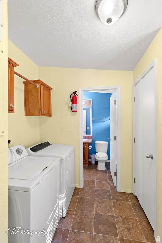 180 N 1100 E Unit 165, Washington, UT 84780 - laundry room with baseboards, washing machine and dryer, a textured ceiling, and laundry area