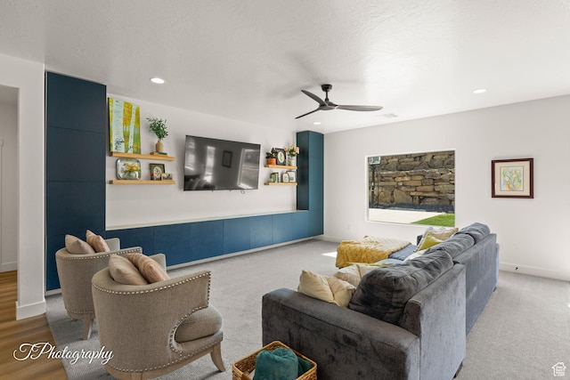 living area with a ceiling fan, a textured ceiling, baseboards, visible vents, and recessed lighting