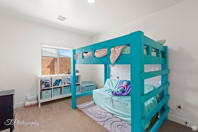 bedroom with carpet floors, baseboards, and visible vents