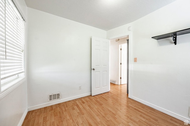 1150 W Girard Ave, Salt Lake City, UT 84116 - empty room with baseboards, visible vents, and light wood-style flooring