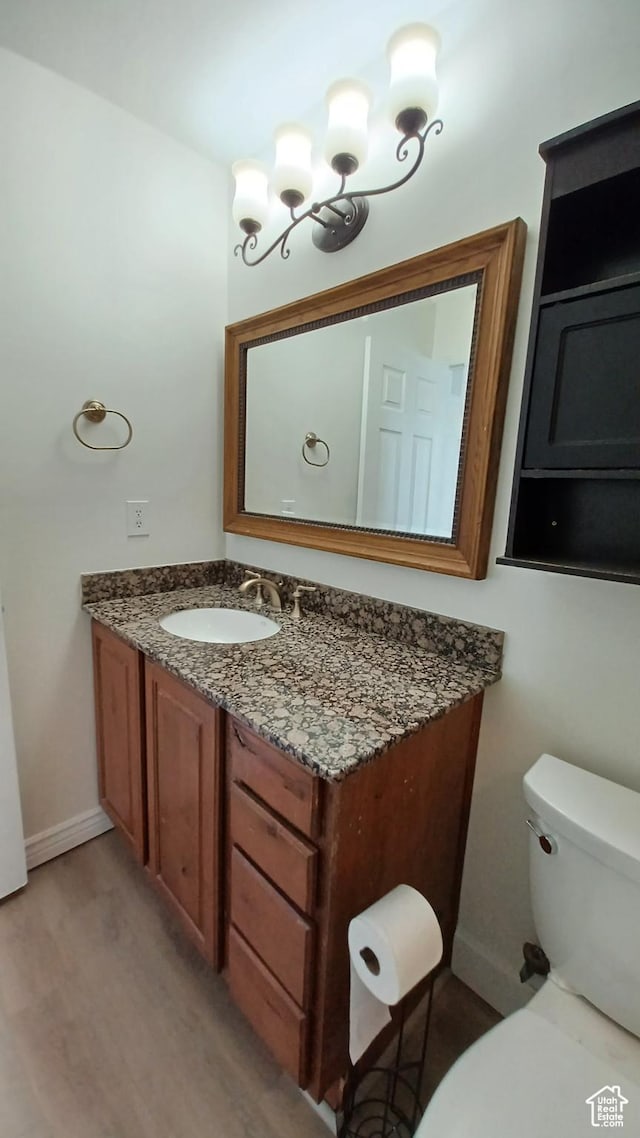 6116 W Graceland Way, West Jordan, UT 84081 - half bathroom with wood finished floors, baseboards, vanity, and toilet