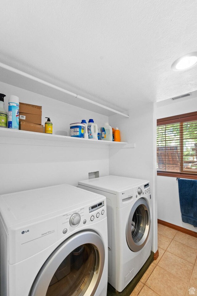 18509 Jefferson Ave, Eagle Mountain, UT 84013 - laundry room with washing machine and dryer, light tile patterned flooring, and baseboards