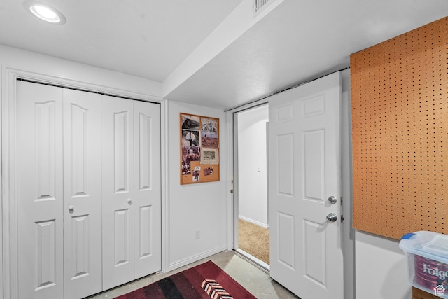 foyer featuring baseboards and visible vents