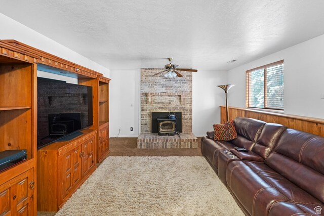 18509 Jefferson Ave, Eagle Mountain, UT 84013 - living area with carpet flooring, a wood stove, a ceiling fan, and a textured ceiling