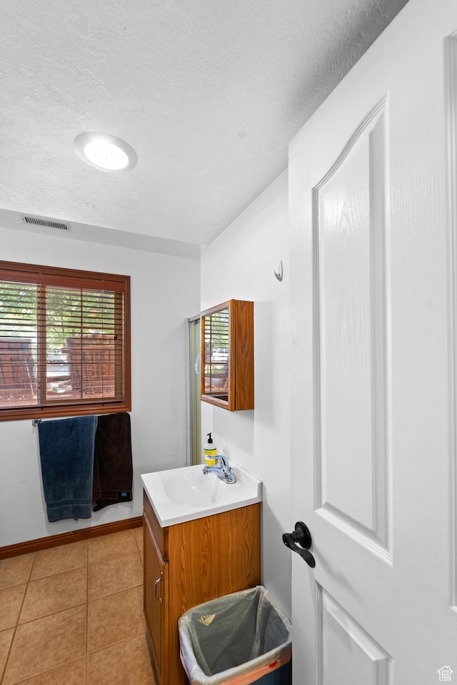 18509 Jefferson Ave, Eagle Mountain, UT 84013 - bathroom featuring vanity, a textured ceiling, tile patterned flooring, and baseboards
