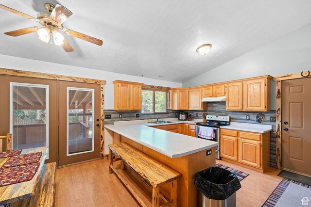 18509 Jefferson Ave, Eagle Mountain, UT 84013 - kitchen with stainless steel range with electric cooktop, under cabinet range hood, light countertops, light wood-type flooring, and vaulted ceiling