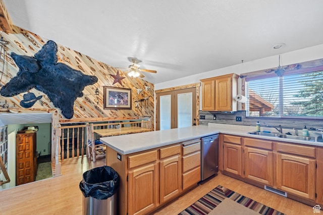 kitchen featuring light countertops, a sink, dishwasher, visible vents, and ceiling fan