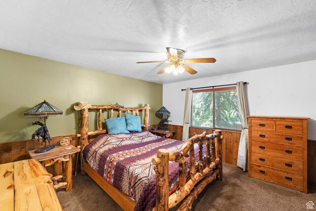 18509 Jefferson Ave, Eagle Mountain, UT 84013 - bedroom with carpet floors, ceiling fan, wood walls, a textured ceiling, and a wainscoted wall