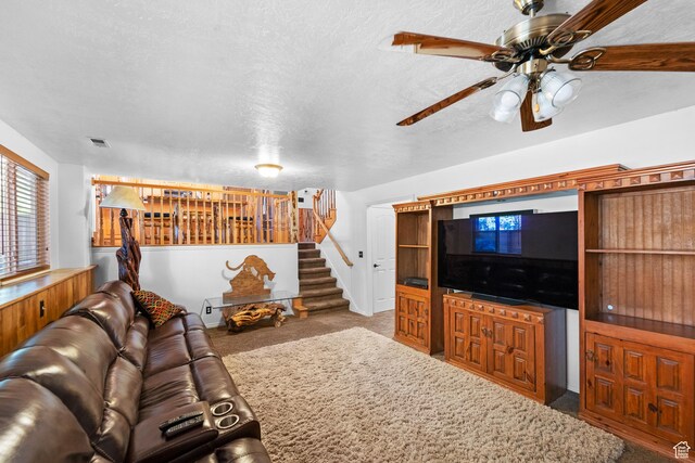 18509 Jefferson Ave, Eagle Mountain, UT 84013 - carpeted living area with stairs, a ceiling fan, and a textured ceiling