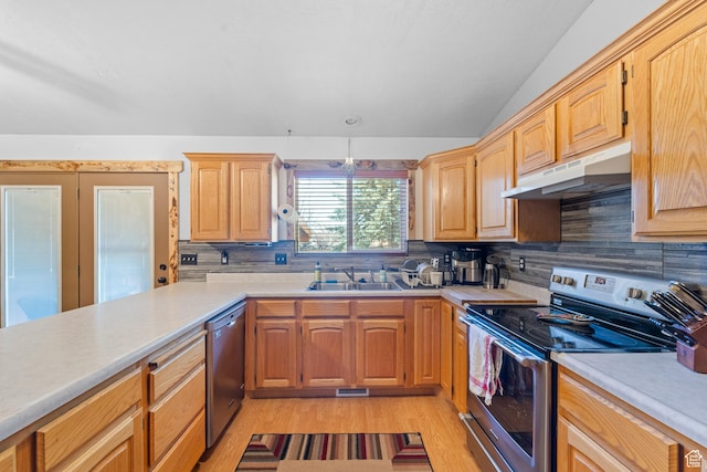 kitchen with light countertops, a sink, appliances with stainless steel finishes, under cabinet range hood, and decorative backsplash