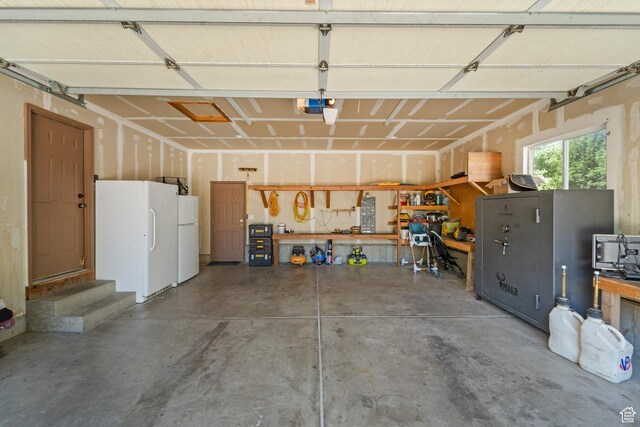 18509 Jefferson Ave, Eagle Mountain, UT 84013 - garage featuring freestanding refrigerator, a workshop area, and a garage door opener