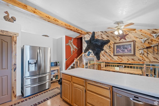 kitchen with light countertops, beam ceiling, light wood-type flooring, stainless steel appliances, and ceiling fan