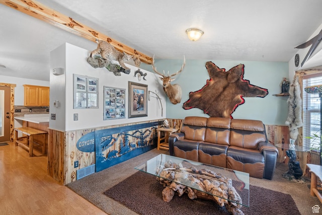 living room with visible vents, light wood-style floors, and lofted ceiling