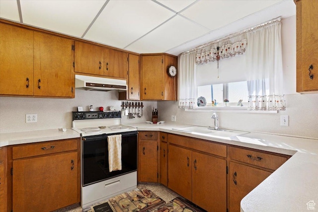 615 S 5900 W, Ogden, UT 84404 - kitchen with light countertops, under cabinet range hood, electric range, a sink, and brown cabinets