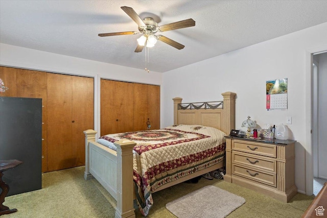 615 S 5900 W, Ogden, UT 84404 - bedroom featuring a textured ceiling, ceiling fan, two closets, and light carpet