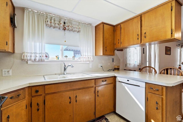 615 S 5900 W, Ogden, UT 84404 - kitchen with brown cabinets, white dishwasher, a sink, and a peninsula