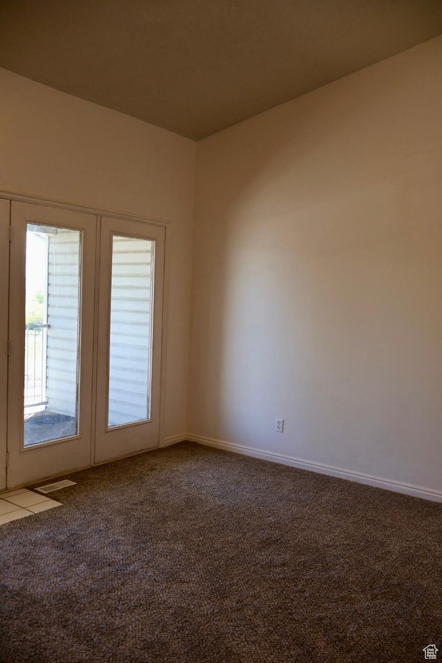 carpeted spare room with baseboards