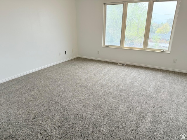 empty room with carpet floors and baseboards