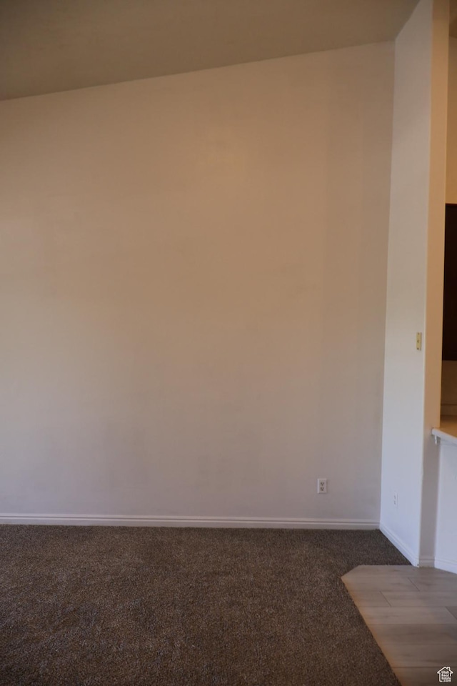 carpeted spare room with baseboards