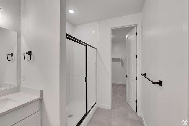 2156 S 4140 W Unit 69, Taylor, UT 84401 - bathroom with a stall shower, recessed lighting, tile patterned floors, vanity, and a walk in closet