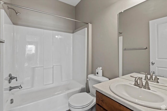 bathroom featuring toilet, vanity, and shower / bathing tub combination