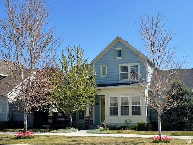 traditional-style house with a front lawn
