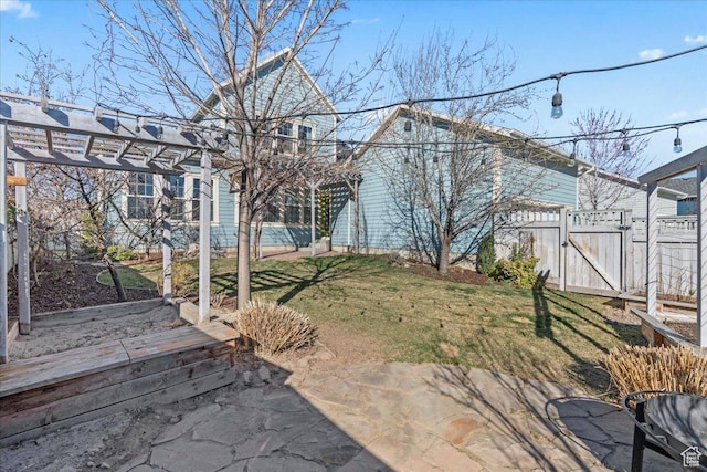 view of yard featuring fence, a pergola, a gate, and a patio area